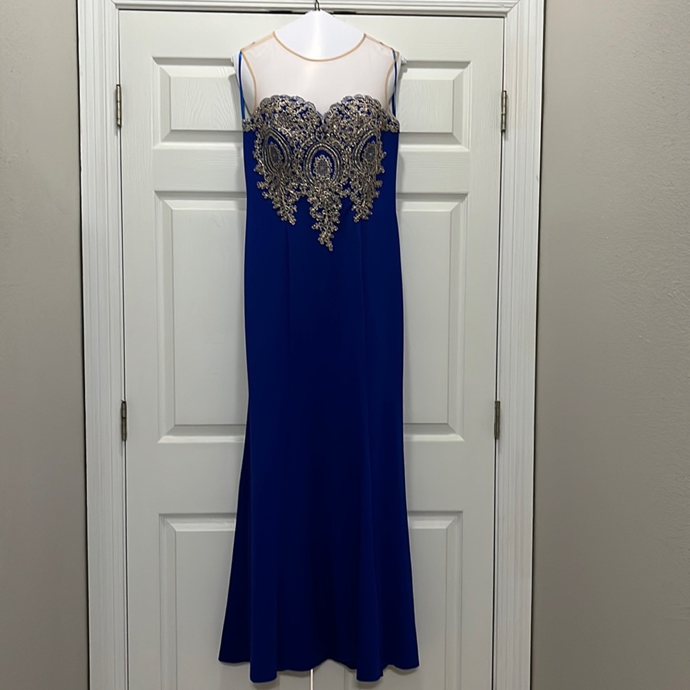 Blue formal gown with mesh neckline and gold embellished bodice
